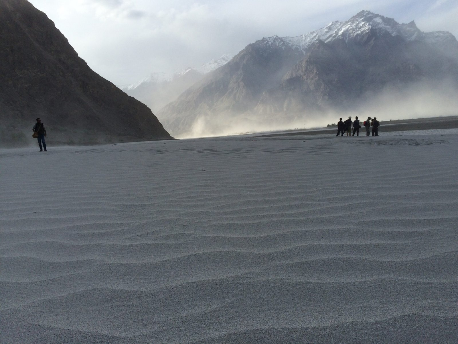 Katpana Cold Desert near Skardu with sand dunes against snow-capped mountains