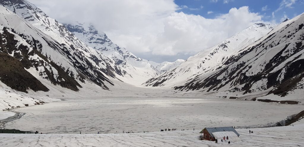 Lake Saif ul Malook in Naran Kaghan surrounded by snow-capped mountains and crystal clear water