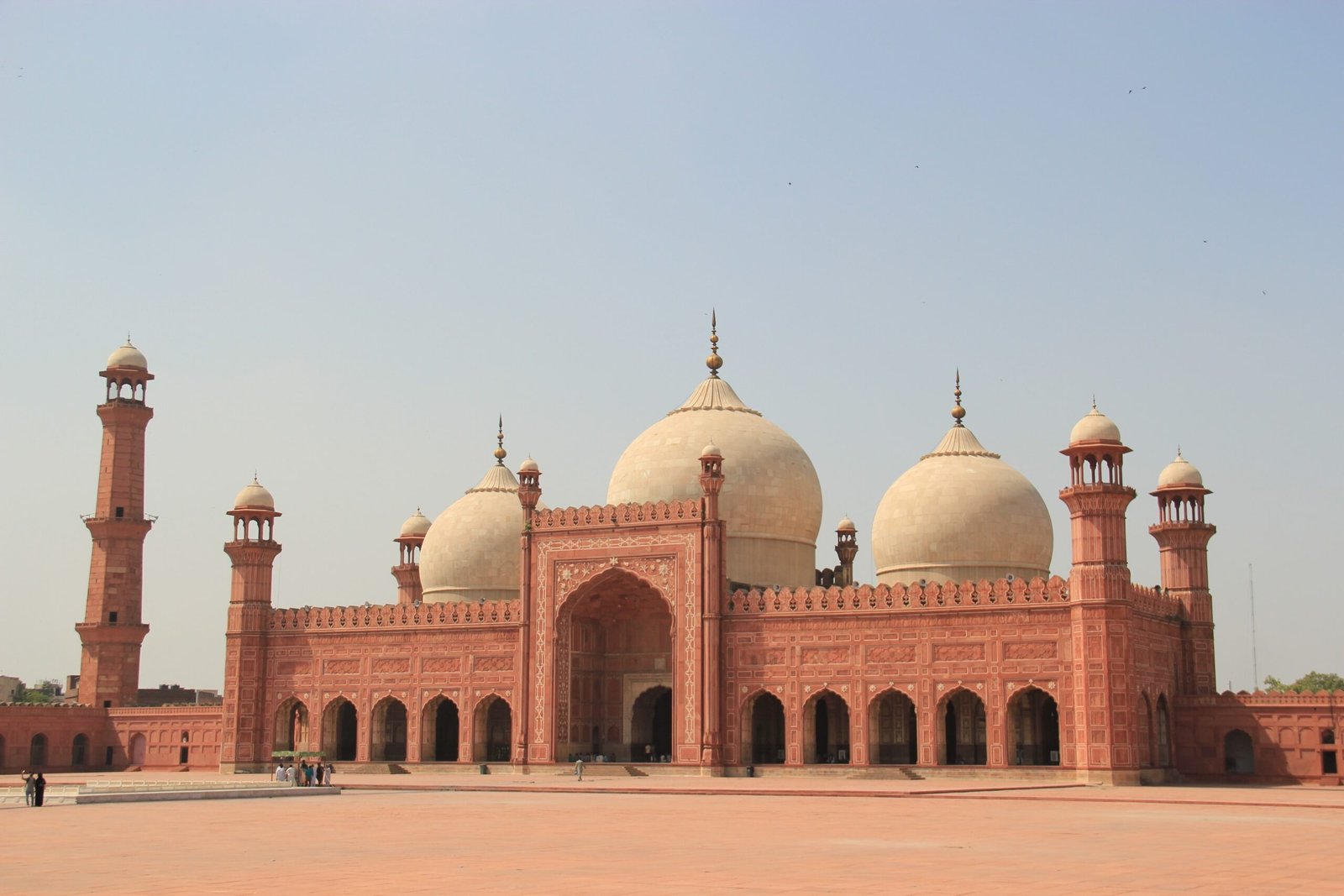 Front view of Badshahi Mosque's red sandstone facade and marble domes in Lahore, Pakistan